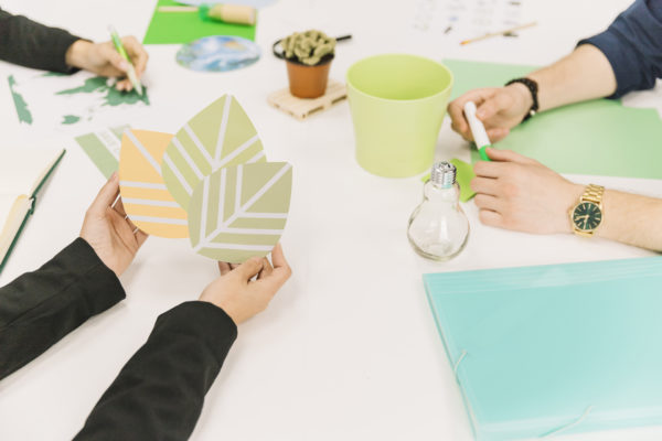 close-up-of-businessperson-s-hand-holding-eco-icon